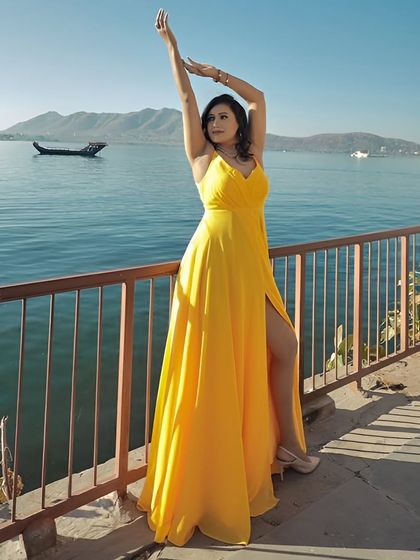 Shine bright in this stunning yellow gown with a thigh-high slit. It’s a bold and beautiful choice for a pre-wedding shoot, especially in a scenic, sunny location.
