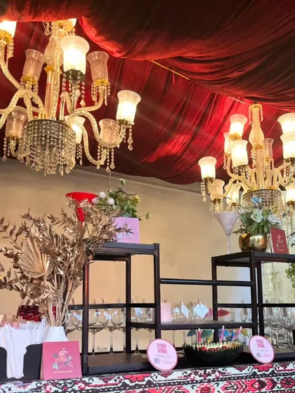 For a truly opulent feel, we combined a traditional patterned bar front with grand crystal chandeliers and metallic gold floral arrangements. This setup is perfect for creating a royal and luxurious ambiance at weddings and grand receptions.
