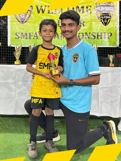 A young player receiving his award. These moments are crucial for building self-esteem and a lifelong passion for sports.