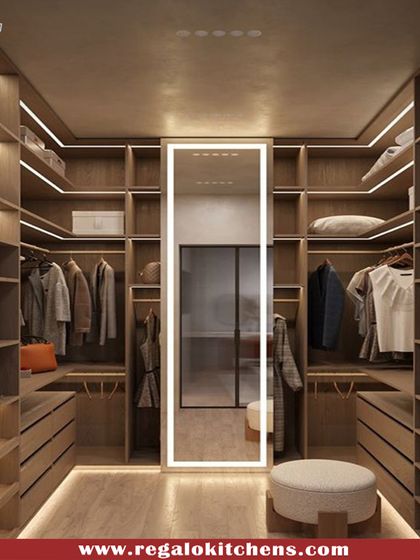 We designed this walk-in closet with a full-length illuminated mirror as a central feature. The warm wood finish and organized shelving create a calm and orderly environment for starting your day.