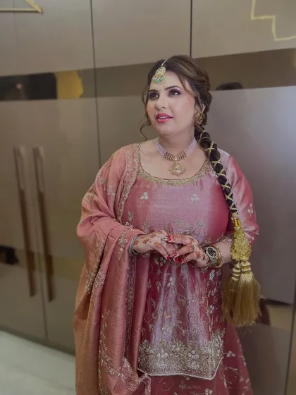 A regal and elegant look for a family wedding. The makeup is kept soft to balance the ornate outfit and traditional jewelry.