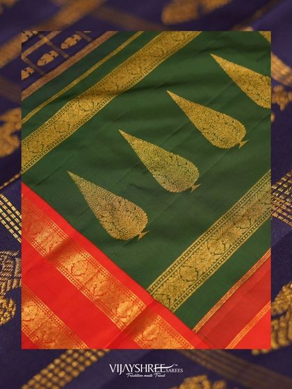 This saree features a Ganga Jamuna border, with two different colors (red and green) on either side of the saree, adorned with Gandaberunda motifs.