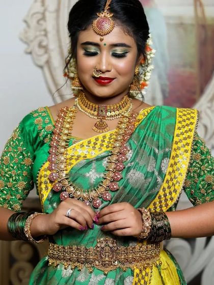 A bride-to-be adorned in our temple jewellery with pink and green stones. This set is perfect for adding a touch of colour to your bridal look.