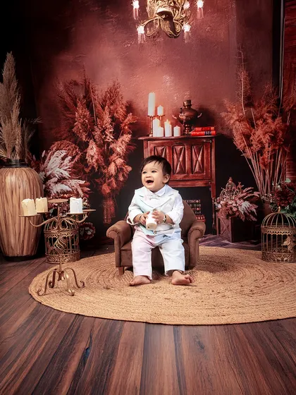 The little brother's turn to shine. His happy giggles light up the room in this solo shot from his sibling photoshoot.