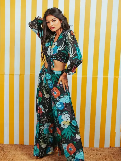 A full-length shot of a different outfit from the same brand, this time a darker floral print. This shows the range within the collection.