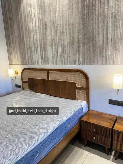 A clearer view of the hotel bed with its matching fluted nightstands.