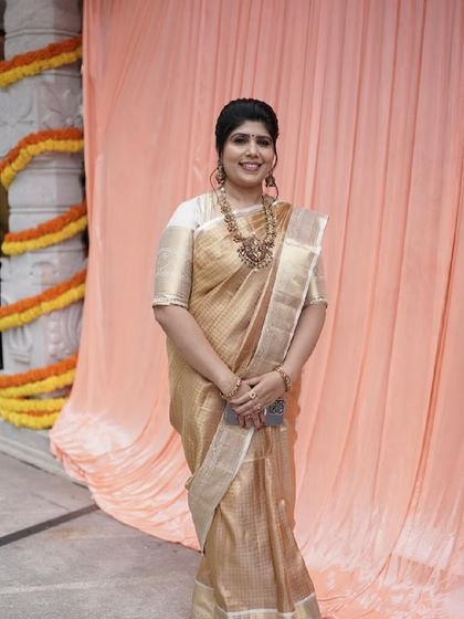 Shilpa at an event, her golden saree shimmering beautifully under the lights.
