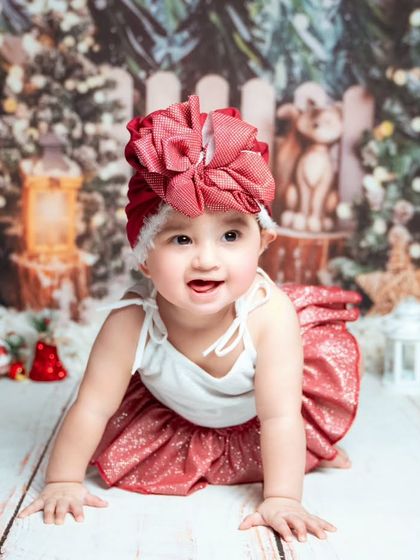 A crawling baby explores the Christmas setup. We let babies play and move around to capture their natural energy and joy.