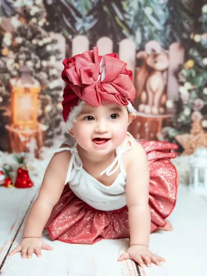 A crawling baby explores the Christmas setup. We let babies play and move around to capture their natural energy and joy.
