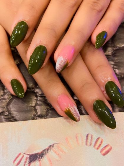 A unique color combination on almond-shaped nails. This design features a two-toned accent nail with a sharp diagonal line separating olive green and a pink-to-gold chrome ombre.