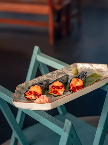 Our Salmon Temaki Roll, where soy-soaked passion fruit spheres add a surprising burst of sweet umami.