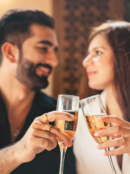 A celebratory moment with a champagne toast. This classic, elegant shot can be part of any pre-wedding theme, adding a touch of sophistication and joy.