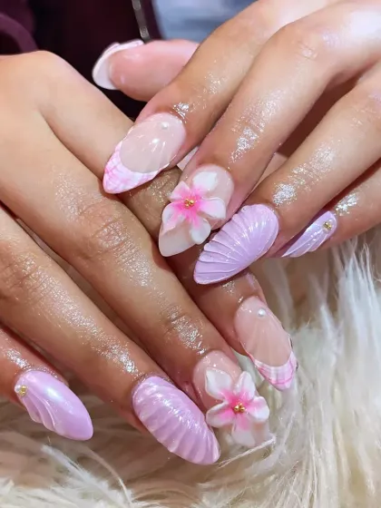Dive into detail with our mermaid-inspired 3D nail art. This set features soft lavender gel extensions with intricate seashell textures and delicate, hand-sculpted flowers. It’s a whimsical yet elegant design that showcases our expertise in creating unique, dimensional nail art.