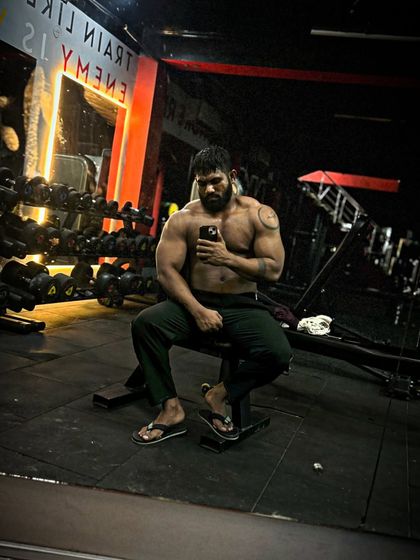 Gaining like a pro. A relaxed pose after a workout, showing the size I've put on during my bulk.