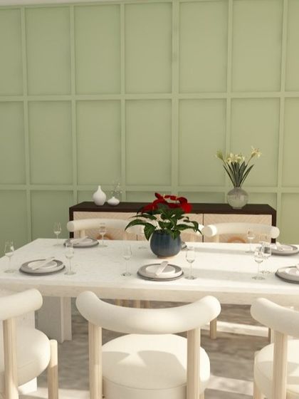 The dining area of this design features a fresh green wall cladding and light-colored furniture, creating an airy and Scandi-inspired feel.