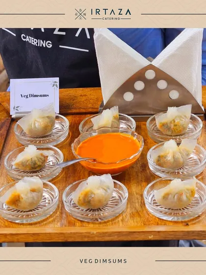 A tray of freshly steamed Veg Dimsums with a spicy dipping sauce. This is a perfect example of the authentic Asian cuisine I can bring to your event.
