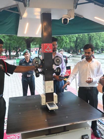 Army personnel get a hands-on demonstration of the features of our Solar Patio, including the charging ports, fans, and integrated CCTV camera for security.