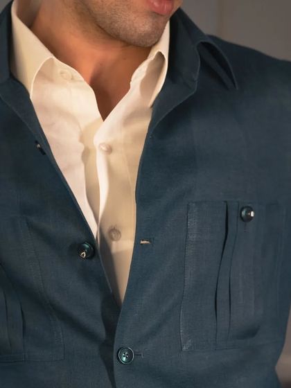 The details, like these classy patch pockets, add functionality and a touch of classic safari style to this modern garment.