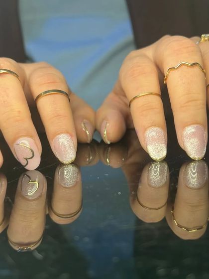 A full view of the lovely glitter and heart-themed manicure.