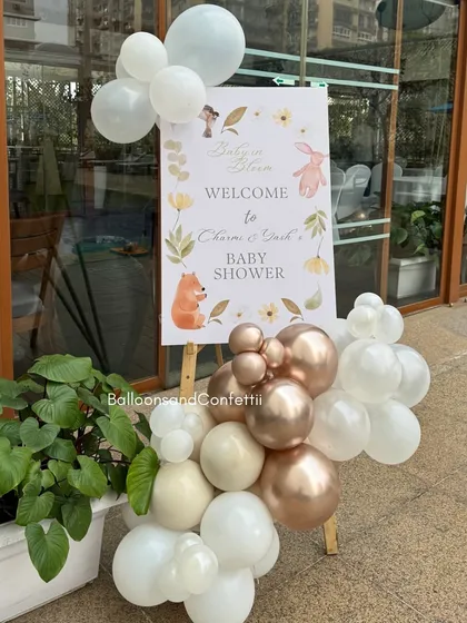 A personalized welcome sign for the baby shower, adorned with a small balloon cluster that matches the main decor. It's the first thing guests see and sets the tone for the event.