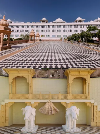 The stunning architecture of Udaipur, featuring the chequered courtyard of the Radisson Blu and a creative shot of the bride's lehenga against a traditional backdrop.