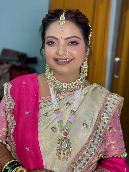 A pastel-themed traditional look, combining a beautiful saree with modern jewelry for a unique bridal style.
