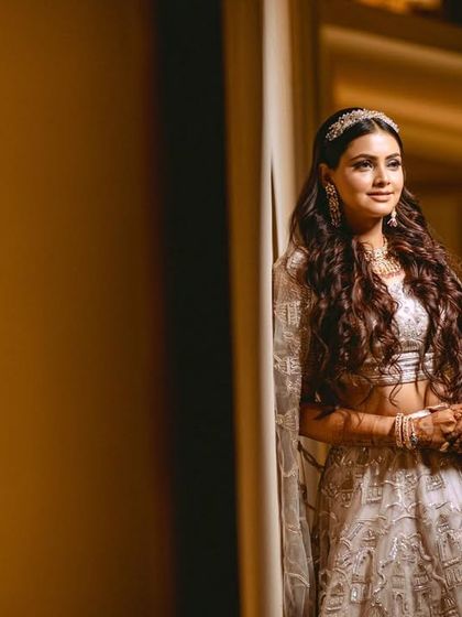 A quiet, elegant portrait of the bride leaning against a wall, the soft lighting highlighting her features.
