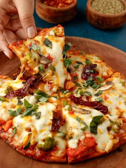 Nothing sells a pizza like the perfect cheese pull. This shot is all about capturing that satisfying, delicious moment that everyone loves, making it an essential photograph for any pizzeria's menu or social media.