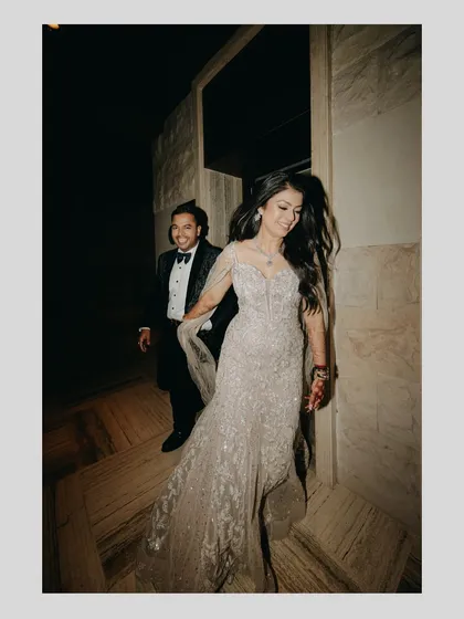 Capturing the joy and movement of the night. This candid shot shows the couple running through the hallway, their laughter and energy making for a dynamic and authentic photograph.