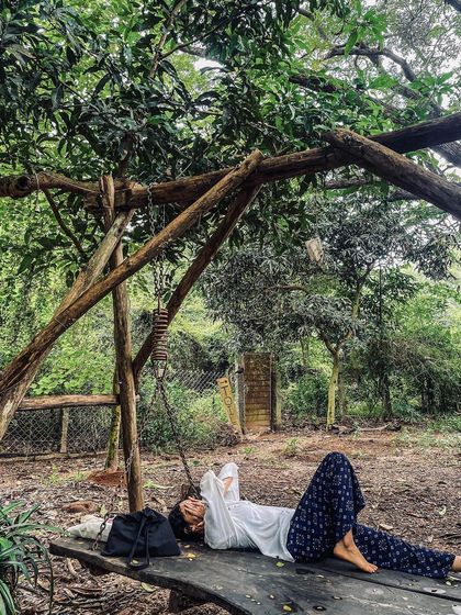 Resting on a swing at an earthy farm, I take a moment to connect with the simple joys of being in nature. My retreats are designed to help you find these pockets of peace and rest.
