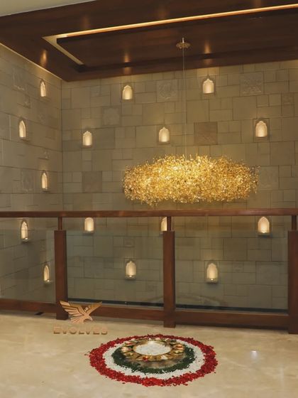 A stunning view of a home's interior during a house warming, with a floral rangoli and an elegant chandelier, creating a grand and auspicious ambiance.