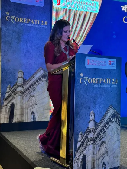 A side view from the podium, reading from my script to ensure all announcements are accurate and timely for the HDFC Life and TJSB Bank event.