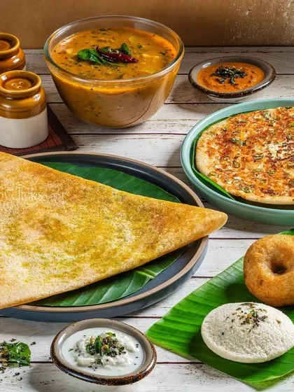 A South Indian platter from Gulab Sweets, featuring a dosa, idli, and vada for a complete meal experience.