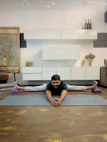 Samakonasana (Side Splits) with blocks under the feet for support. Using props is a smart way to work towards the full pose safely.