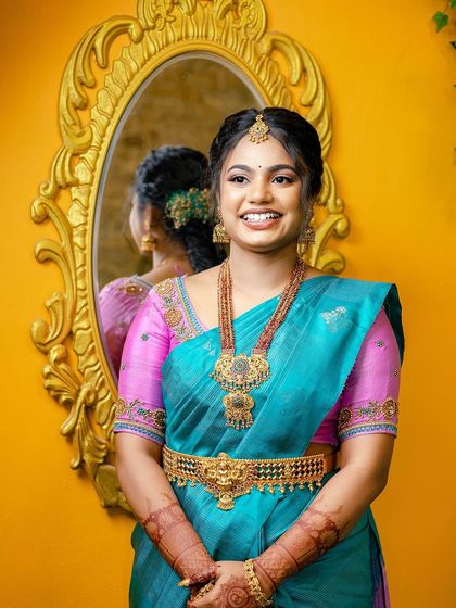 A beautiful portrait of Sugirtha, with a mirror reflection. Her makeup is soft and glowing, and her smile is absolutely radiant.