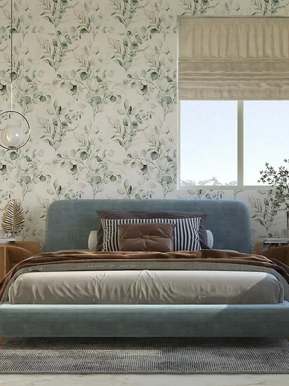 This bedroom design is minimalist yet classy. We used a delicate, leafy wallpaper to create a feature wall, paired with a simple, elegant bed in a soft blue fabric to create a space that feels balanced and serene.