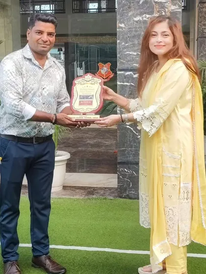 Our Principal felicitates a coach from our gymnastics team. We proudly celebrate our team's achievement of winning the Best Disciplined Team Trophy at the Inter-School Artistic Gymnastics Championships.