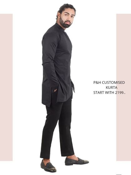 The side profile of the black asymmetrical kurta, showing its unique silhouette.