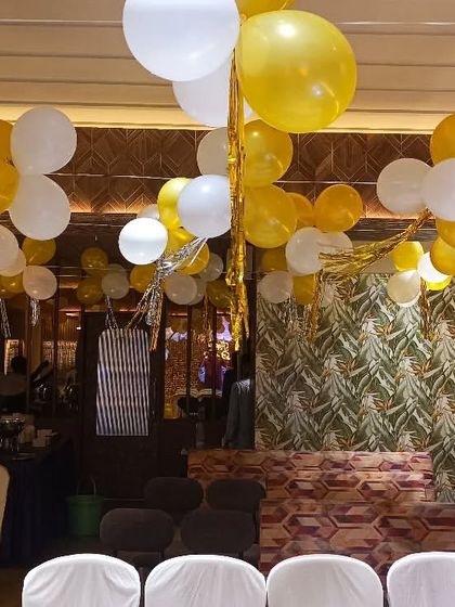 We filled the ceiling with yellow and white balloon bunches to match the main decor, ensuring the entire room felt festive for this 13th birthday.