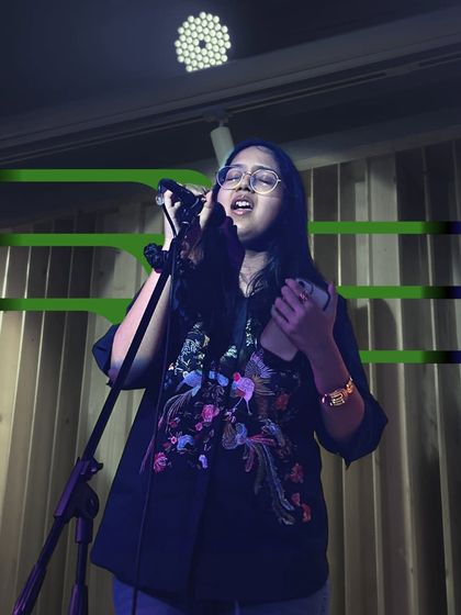A singer connecting with the audience. We teach our students that performance is about more than just hitting the right notes; it's about communication.