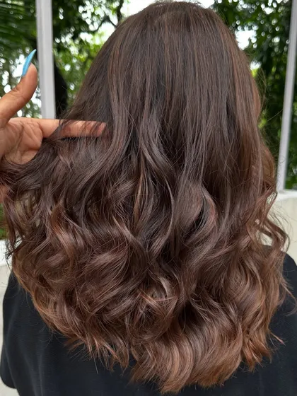 This 'Cinnamon Chocolate' color is perfect for adding warmth and spice to dark hair. The cinnamon tones really pop against the deep chocolate base, especially when styled with waves.