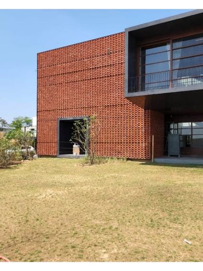 The 'Ishtika' house, showing the relationship between the solid brick-screened volume and the open, glazed living spaces.