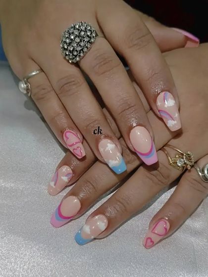 A dreamy set with a pink and blue ombre sky, fluffy clouds, and cute heart details.