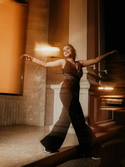 A dynamic portrait of the bride dancing, captured with a slow shutter speed. The motion blur beautifully conveys her movement and the joyful energy of the moment.