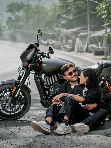 For the couple with a bit of an edge. Posing with a Harley on a mountain road, this shot is all about cool, adventurous vibes. Perfect for telling a different kind of love story.