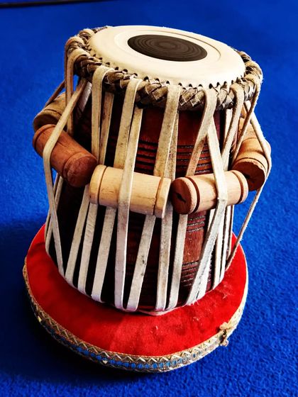 A close-up of a delivered D-sharp tabla made from shisham wood. The 5.5-inch drum is crafted for a sharp, clear tone, ideal for solo performances and accompaniment.