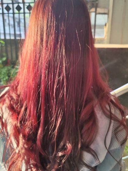 The final result of a vibrant red hair color treatment. This image showcases a bold and confident look, proving our students are trained in a wide range of color palettes.