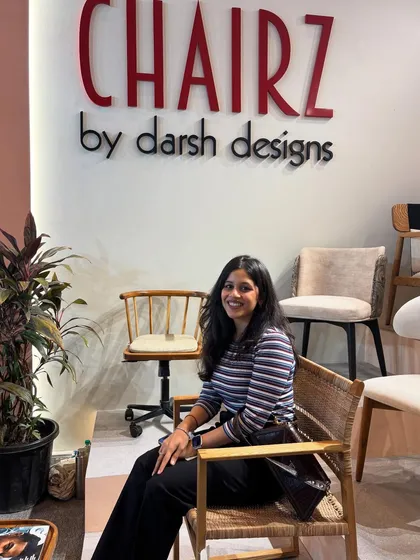A happy visitor trying out one of our cane and wood armchairs. Thank you for stopping by during our precious moment.