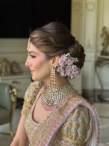 A perfect profile of the bride and her elegant floral bun.