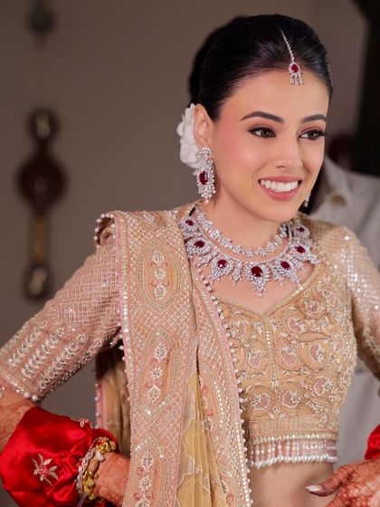 The joy of a bride seeing her final look. Her smile says it all. The makeup is designed to enhance happiness and confidence.